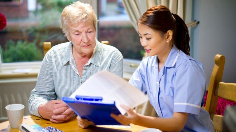 Image of an adult social care worker and and an elderly woman